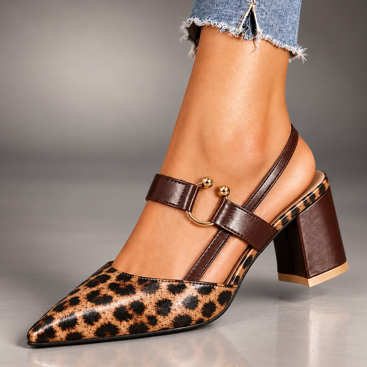 Marigold leopard print slingback heels worn with jeans, angled view showing pointed toe and block heel