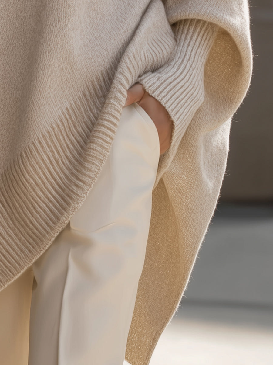 Eugenie oversized relaxed-fit sweater, side view showing the asymmetrical hem