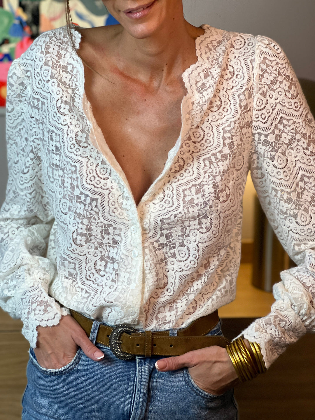 Hedda blouse in Beige styled with denim, hands in pockets showing the relaxed dress-up-or-down look