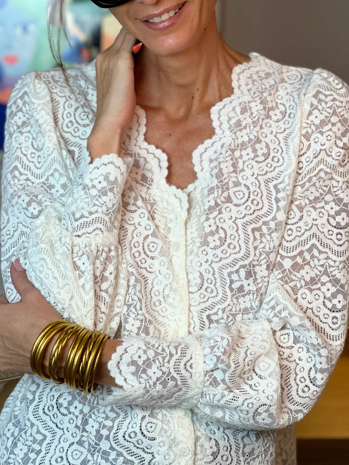 Hedda blouse in Beige with gold bangles, relaxed styling shot