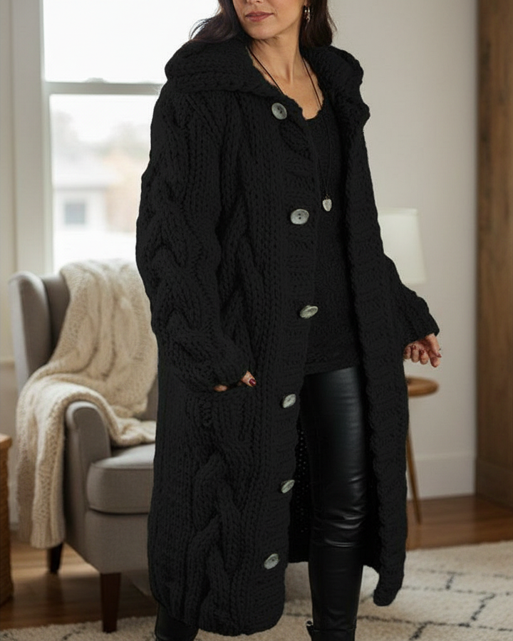 Maribelle black hooded cable-knit cardigan in a cozy living room