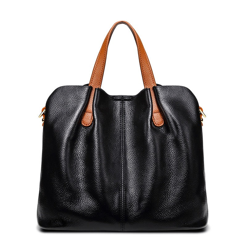 Gemma genuine leather handbag in black litchi grain leather with tan top handles and a central front seam