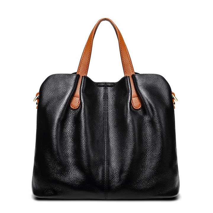 Gemma genuine leather handbag in black litchi grain leather with tan top handles and a central front seam